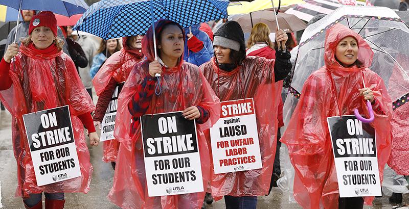 LOS ANGELES, CA - JANUARY 14, 2019   Teachers in a sea of umbrellas march up 3rd street over the 110 Freeway in downtown Los Angeles as they marched to LAUSD Headquarters from City Hall Monday on first day of the Los Angeles school teachers strike January 14, 2019. (Photo by Al Seib / Los Angeles Times via Getty Images)