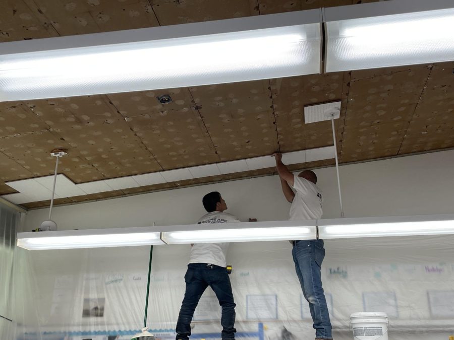 Construction crews filling in the gaps of a classroom ceiling last December. Photo credit: Brian Guerrero.